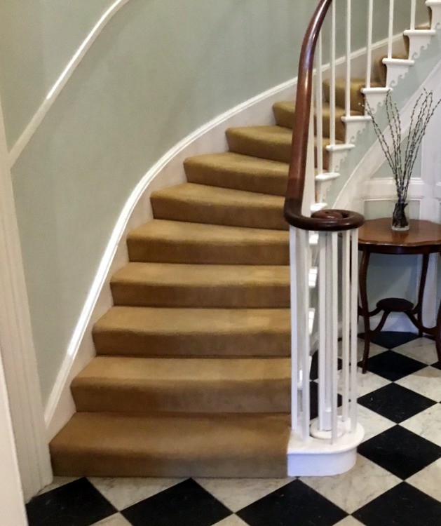 The staircase at Fernhill hotel Charmouth with curved bannister ending in a scroll
